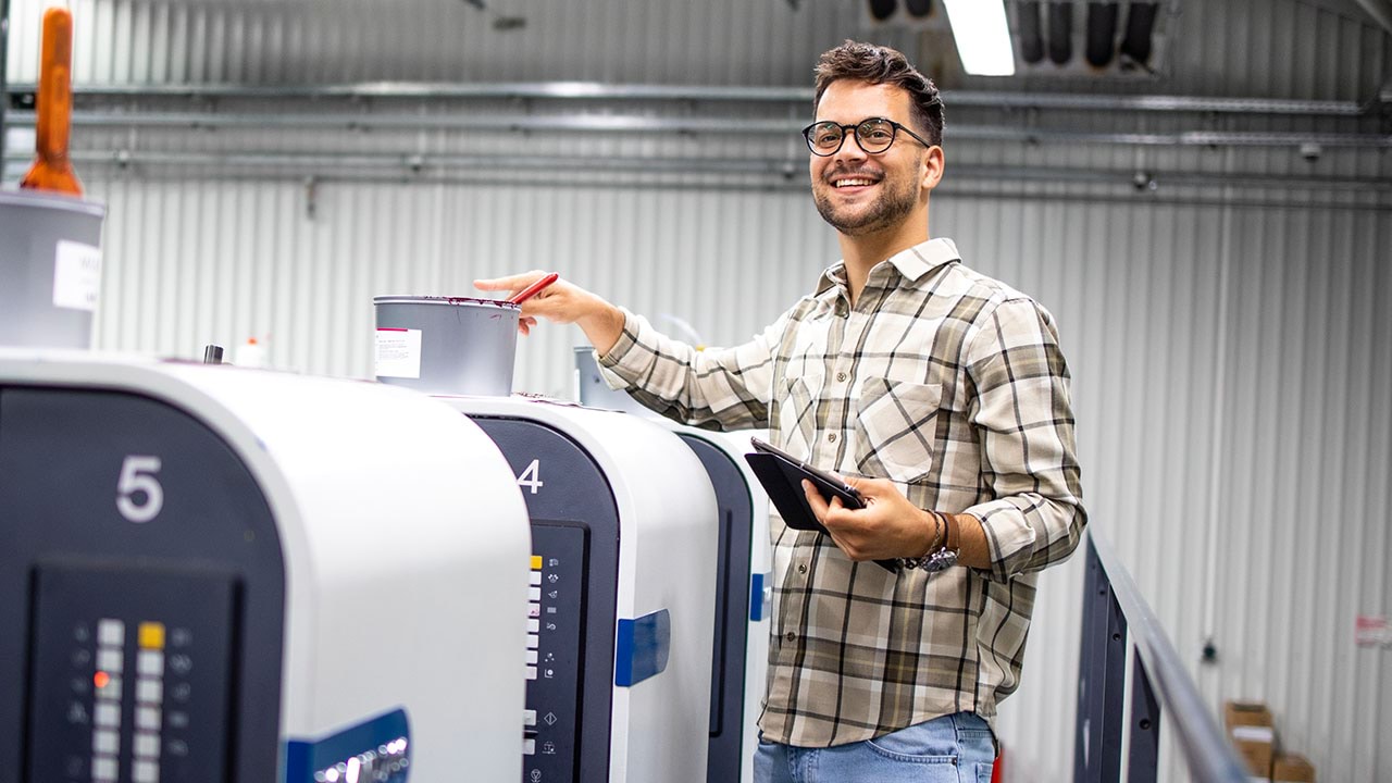 Person working on industrial printer