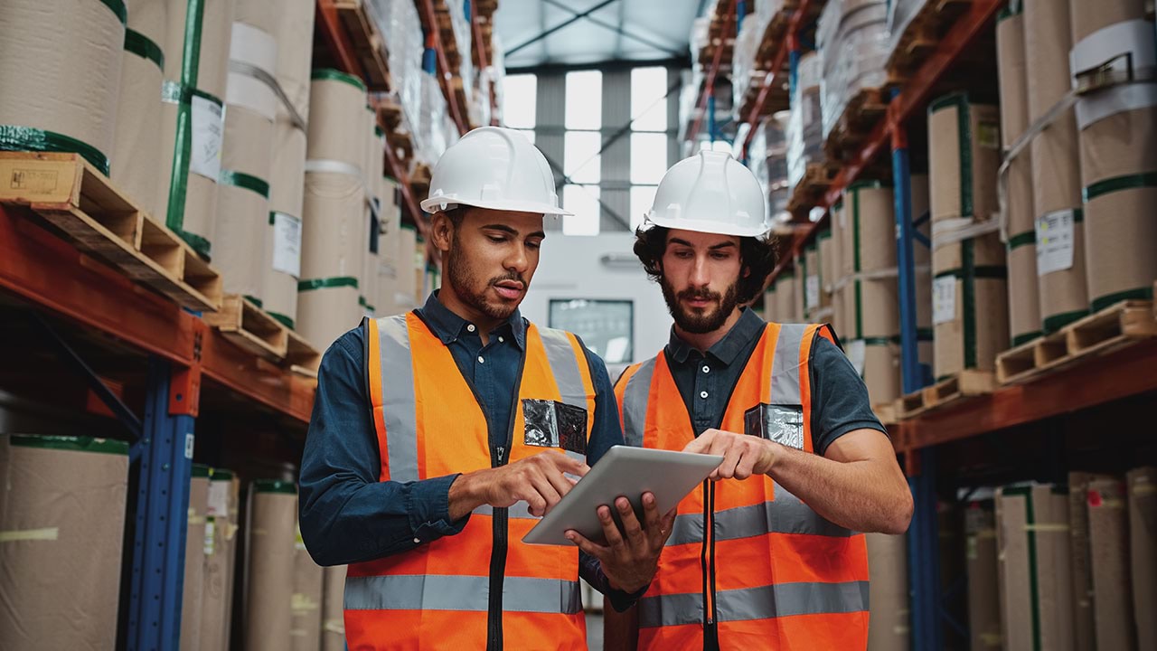 Two people working in a warehouse setting