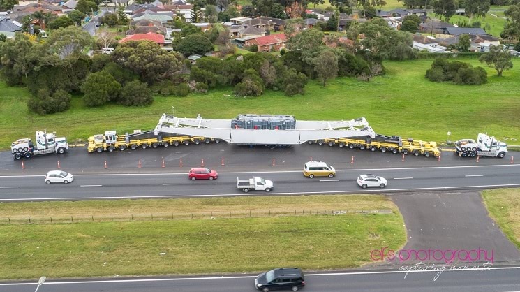 Trucks either side of a structural component by the roadside