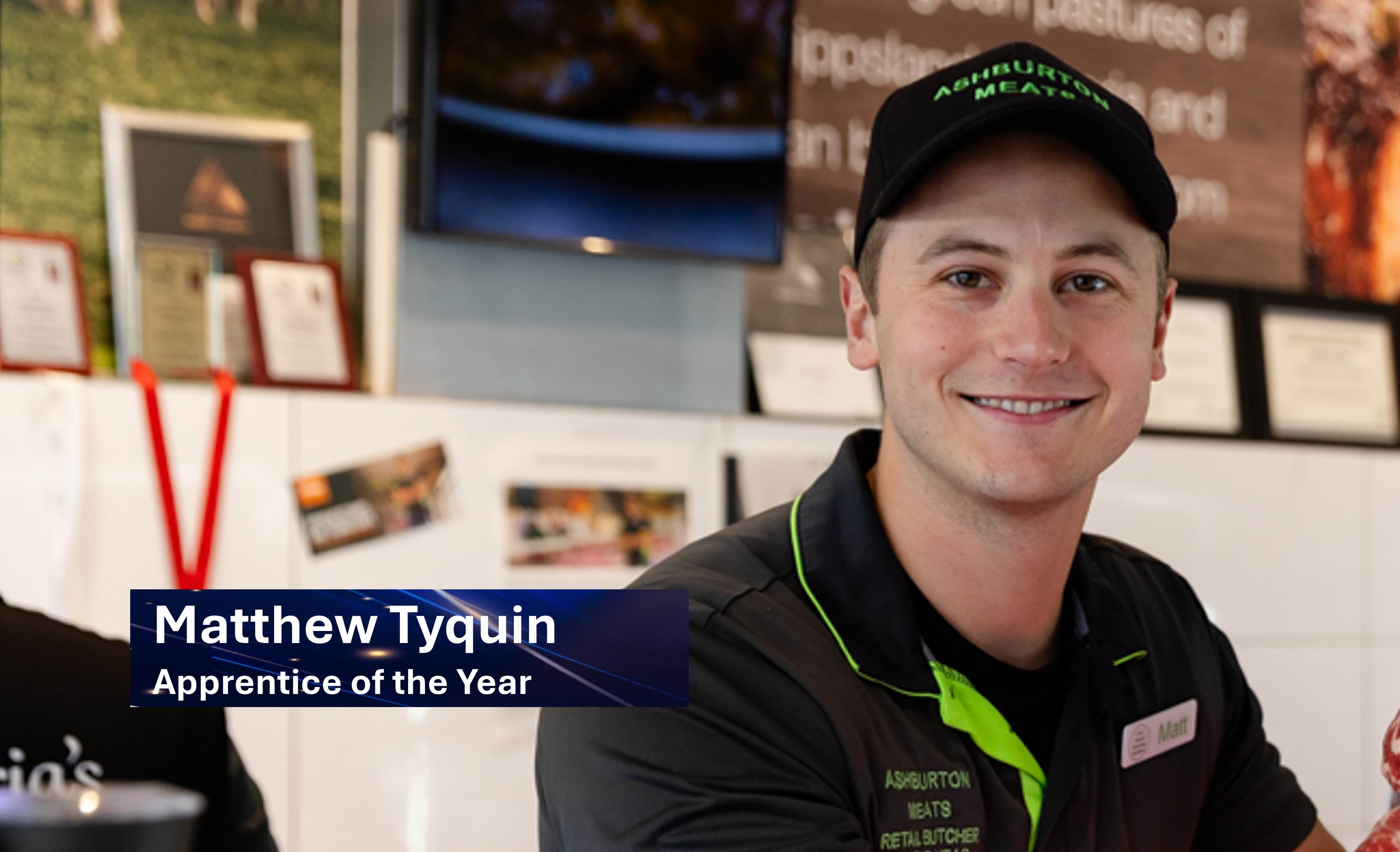 Matthew Tyguin smiling in a butcher shop