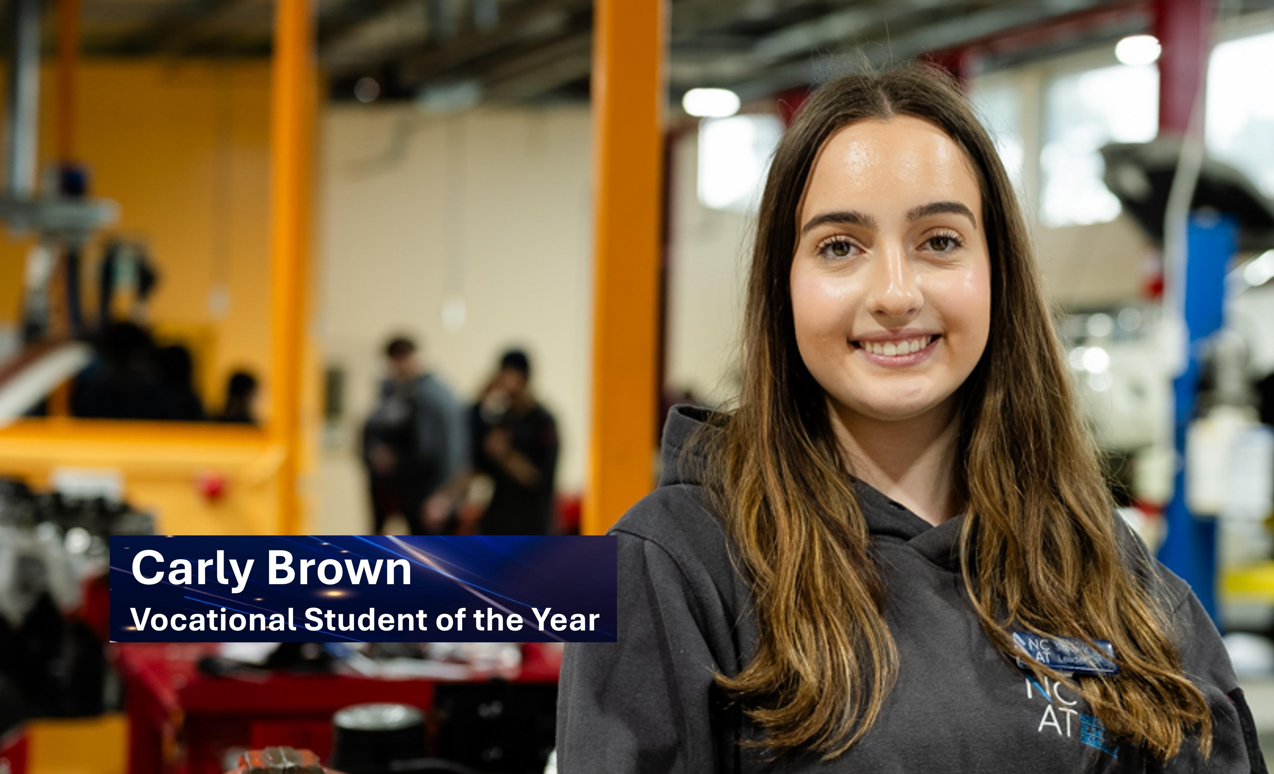 Carly Brown smiling in a workshop