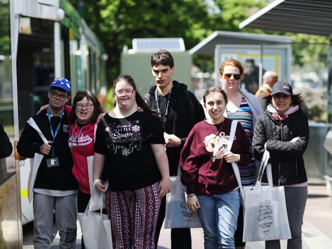 Photo of a group of people participating in the Try Before you Ride program walking along a tram stop platform