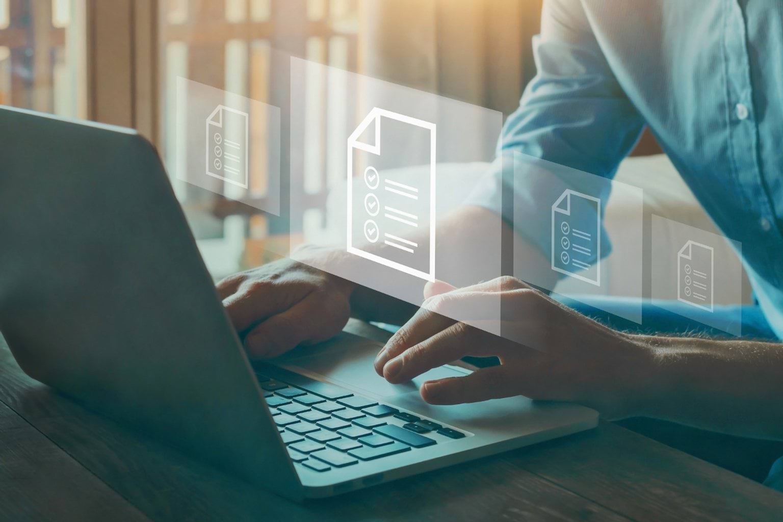 Digitisation A man is working on his laptop wearing a blue business shirt