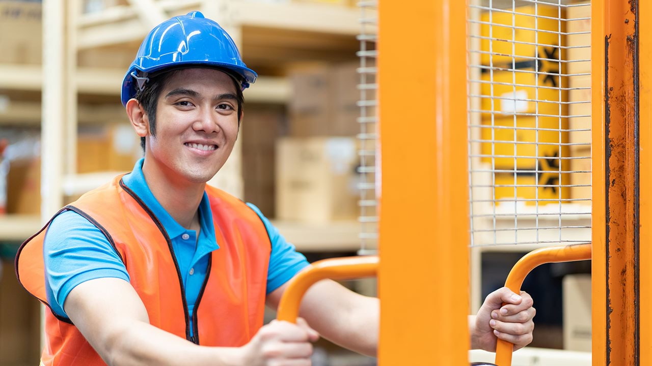 Warehouse employee pushing a trolley