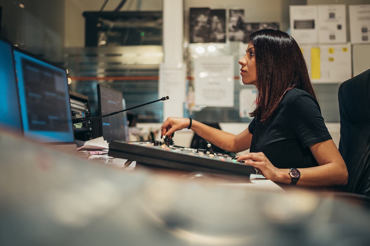 Woman working in a broadcast control room 