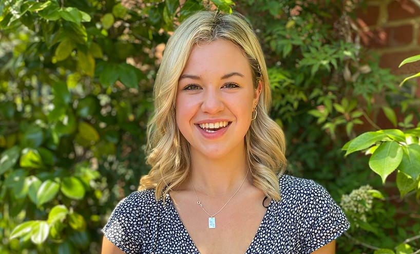 Woman with blonde hair smiling.