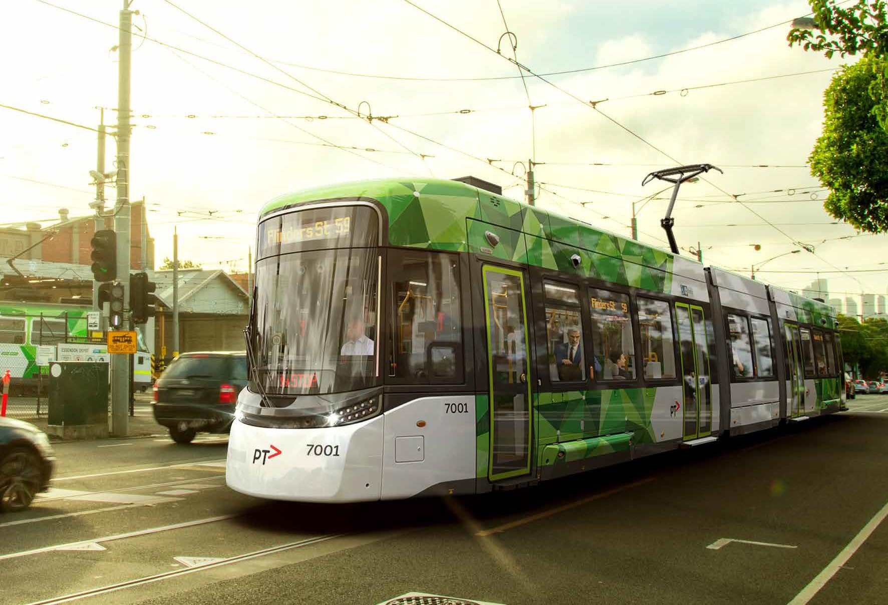 G Class tram with “Flinders Street” displayed on the destination screen, travelling along a Melbourne road with an SUV passing in the opposite direction.