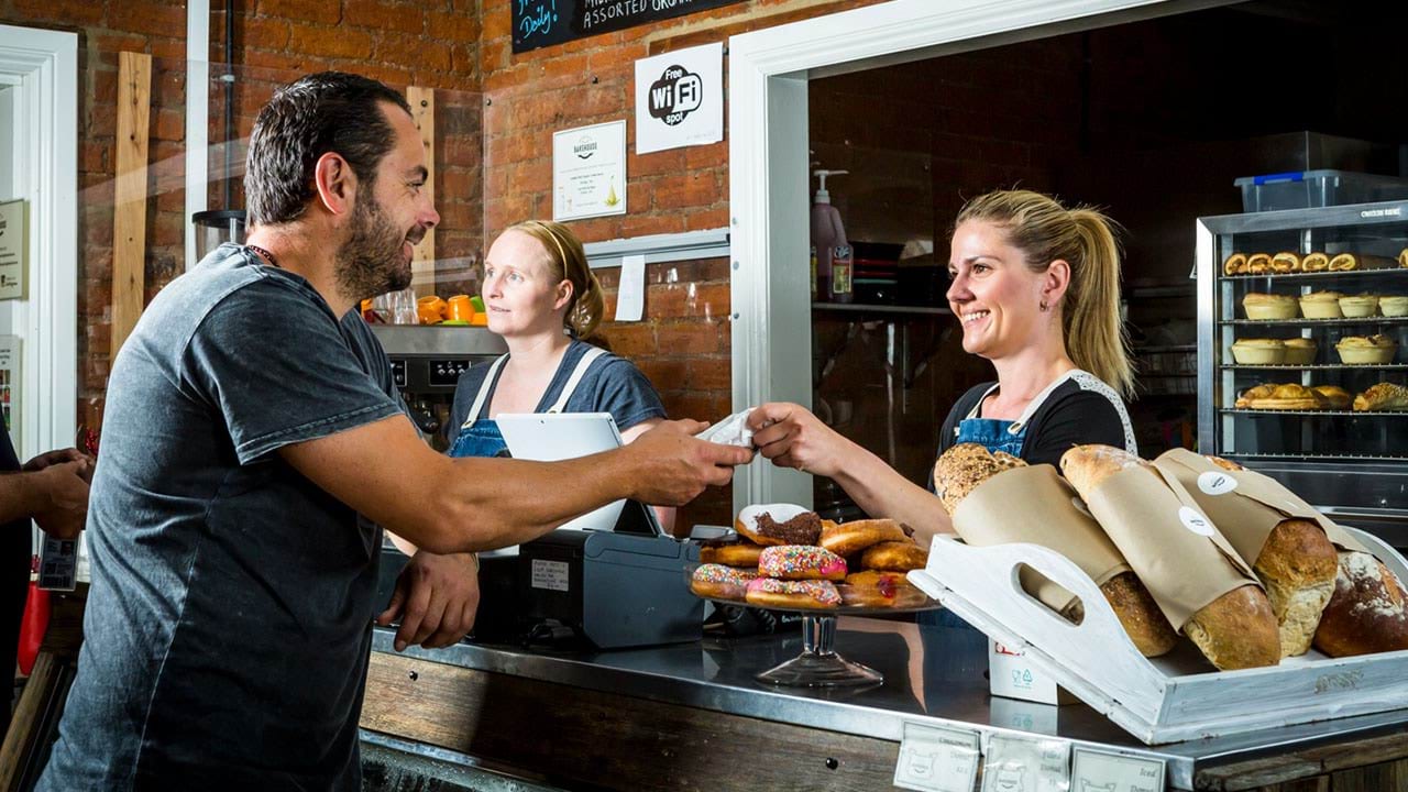 Person serving a customer in a bakery