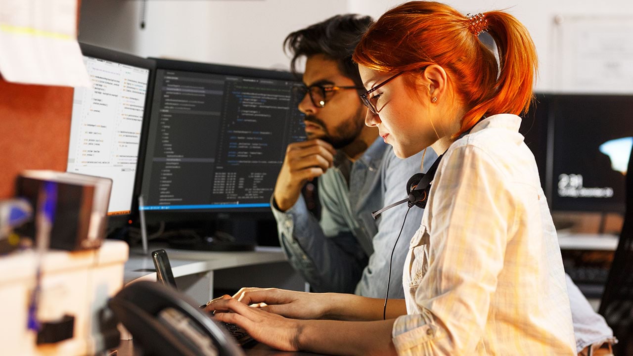 Two programmers working at a computer