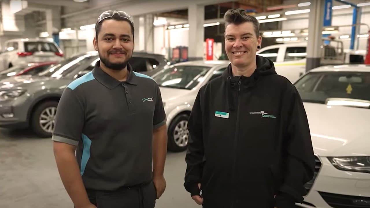 Two people working in a mechanic workshop