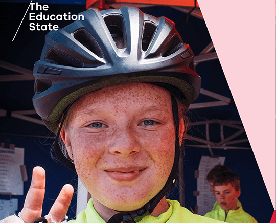 Primary school aged girl wearing a bike helmet.