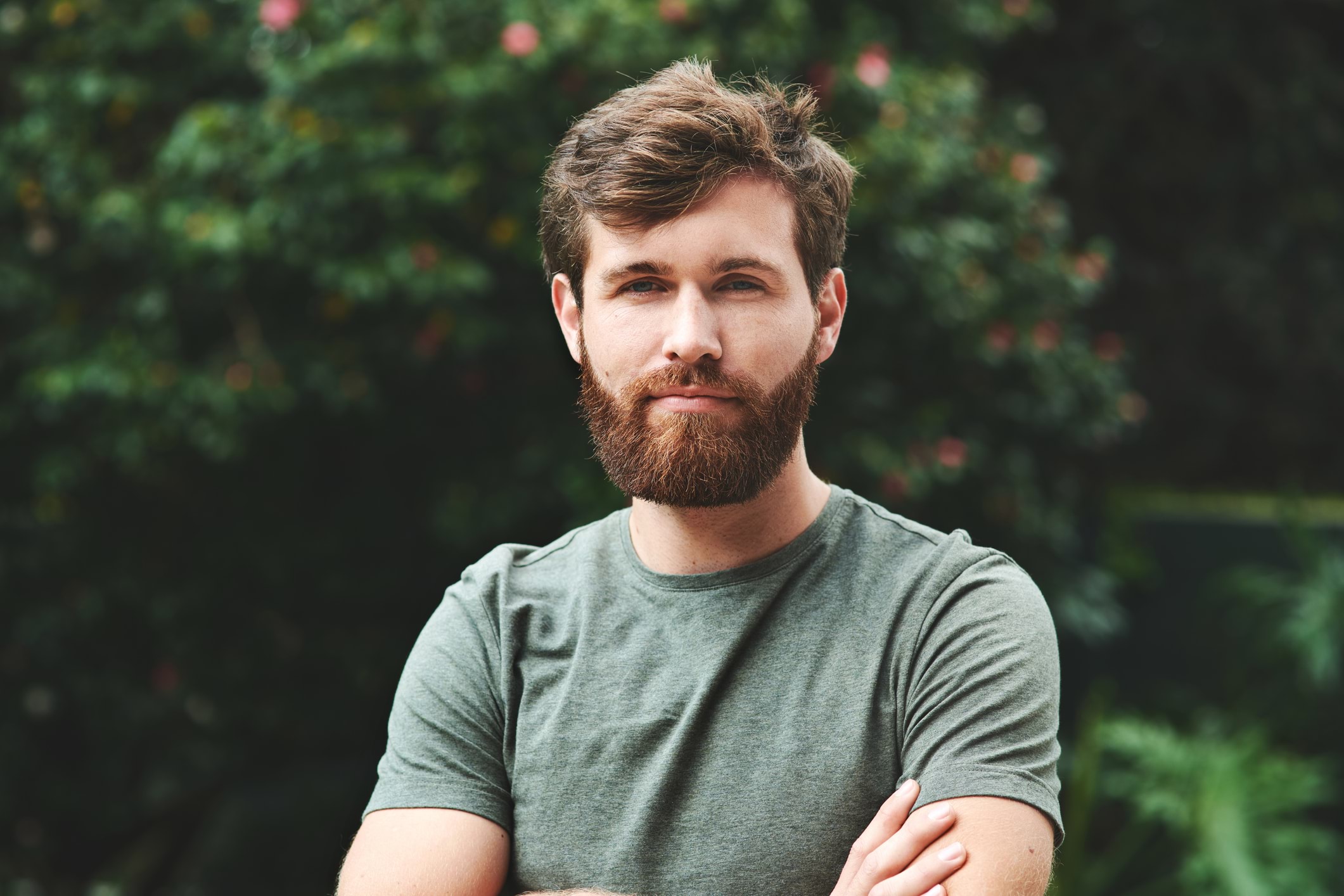 White man looking at camera with arms crossed