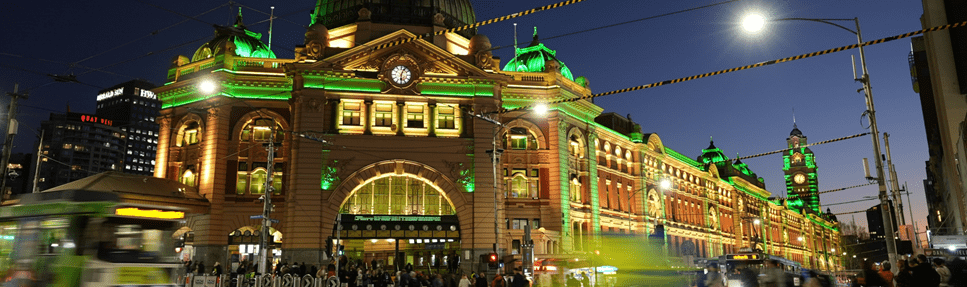 Flinders Street train station lit up at night