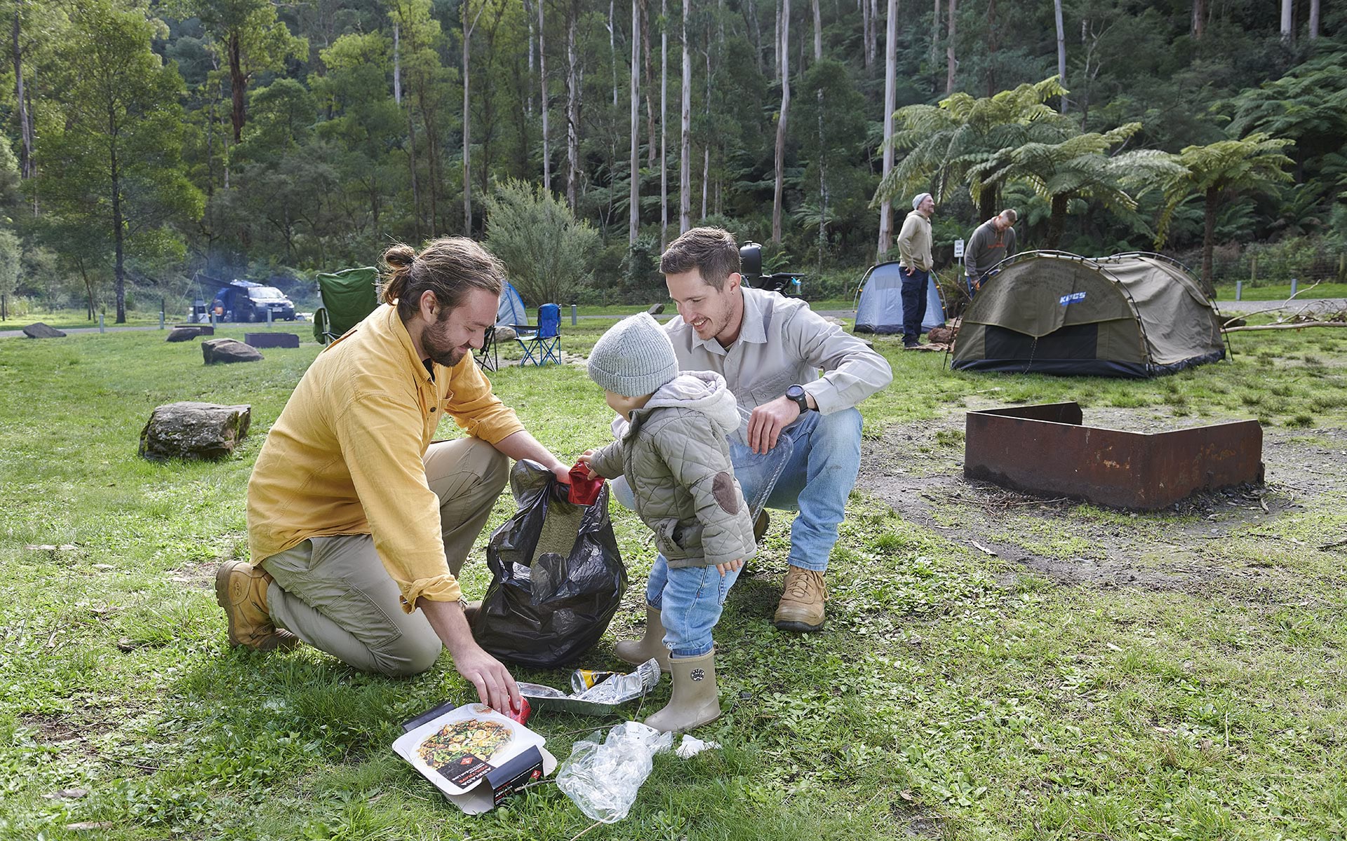 Campers cleaning up rubbish at campsite