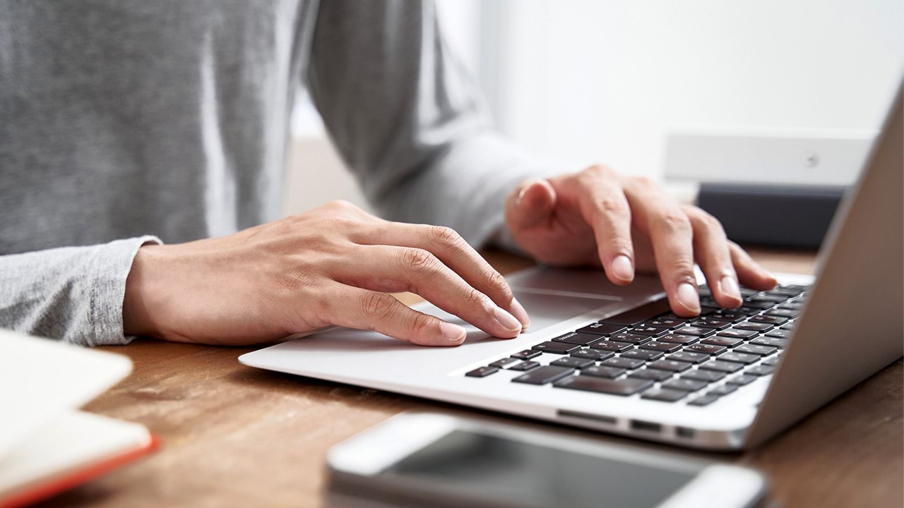 Person typing on laptop on desk