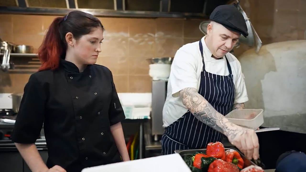 Employer satisfaction survey participant Michael and an apprentice chef in a commercial kitchen