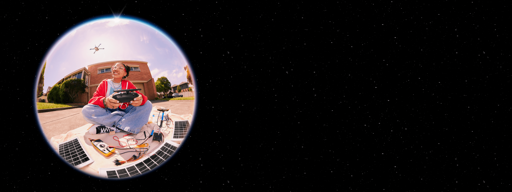 Teenage girl operating a solar-powered drone.