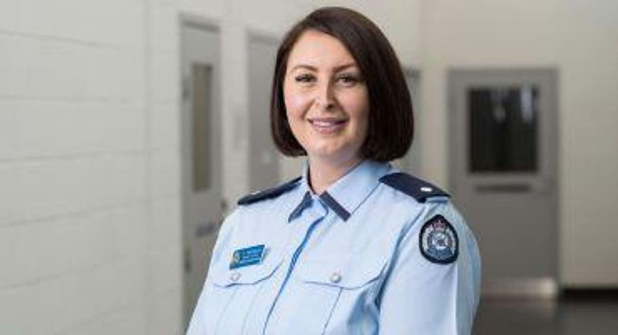 A smiling female prison officer A smiling female prison officer