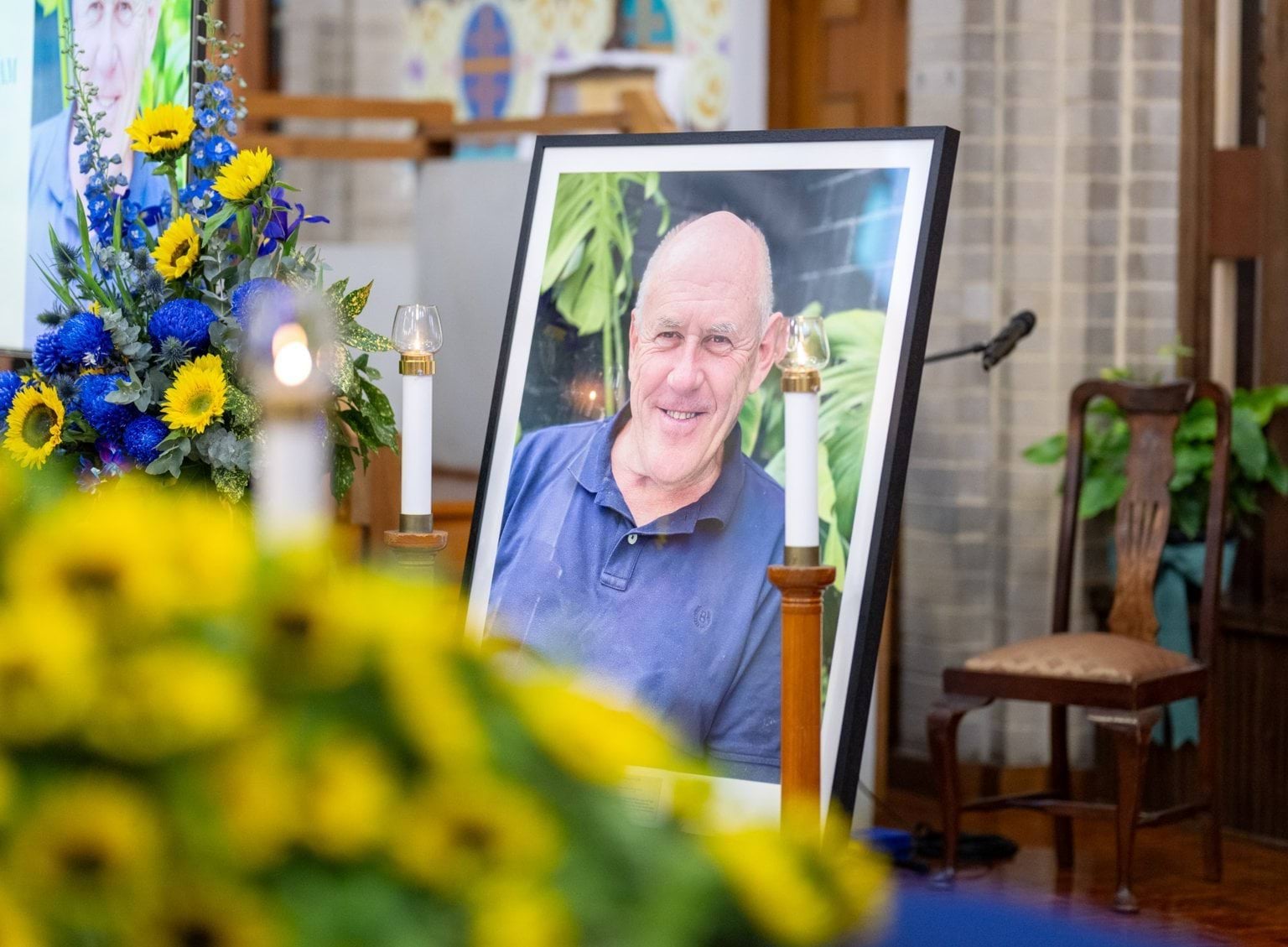 Portrait and flowers at State Funeral Service for Stefan Romaniw OAM