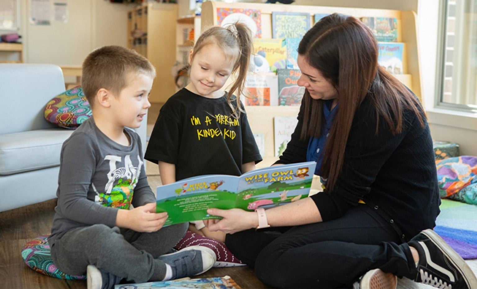 Early Childhood Workforce Register An educator reading a book to two children